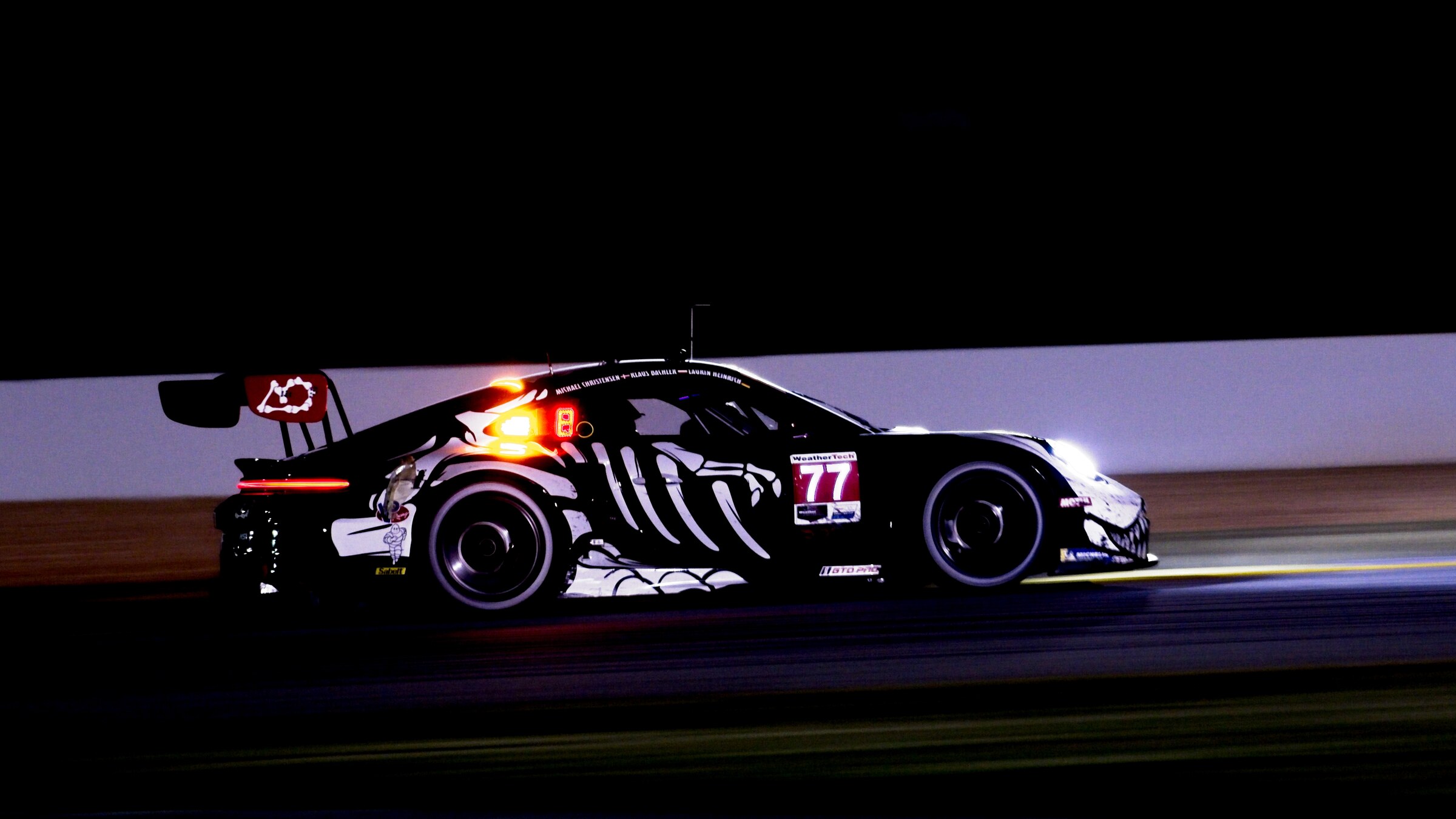 AO Racing number 77 Porsche 911 GT3 R in the Skeleton Rexy livery at Petit Le Mans in 2025