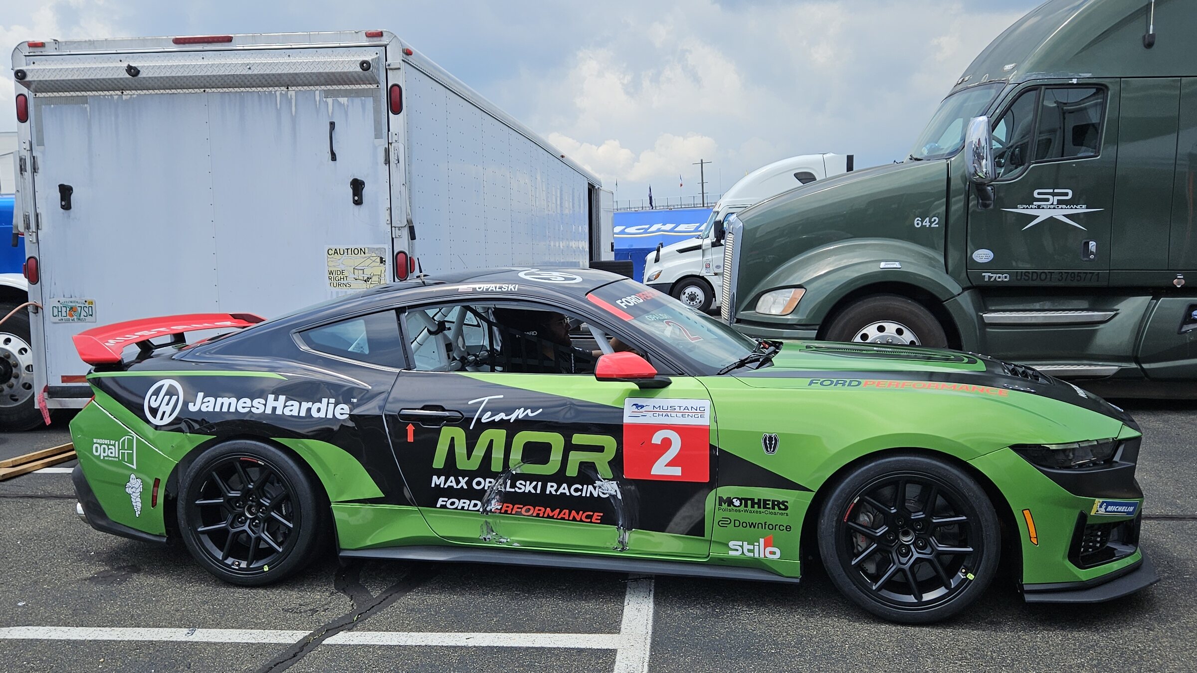 Ford Mustang Dark Horse R customer race car in a paddock at Watkins Glen International